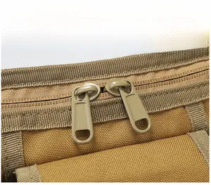 Close-up of matte khaki metal zippers on high-density tactical nylon shoulder bag