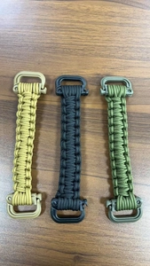 Detail of paracord water bottle handles in khaki, black, and army green colors