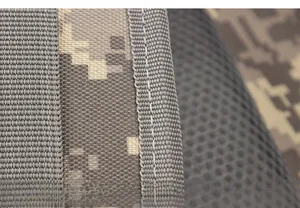 Detail of digital camouflage fabric with reinforced stitching and breathable mesh back padding