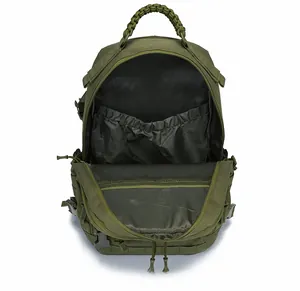 Detail view of military green tactical backpack interior with mesh pocket and elastic strap