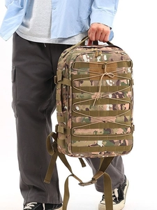 Detail of tactical backpack with Molle webbing system and elastic cord in camo finish