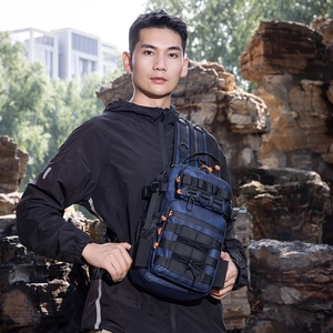 Detail of blue camo tactical chest pack featuring Molle system and orange zipper pulls