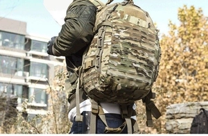 Detail of laser-cut MOLLE system on multicam tactical backpack with ergonomic padded straps