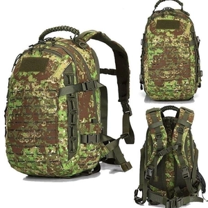 Macro view of tactical backpack featuring laser-cut MOLLE system and digital camouflage
