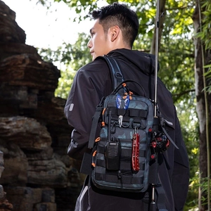 Macro detail of camouflage tactical chest bag with fishing gear and MOLLE attachment system