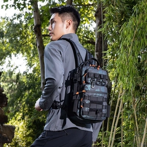Detail of tactical camouflage backpack with MOLLE webbing and bright orange zippers