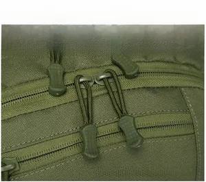 Close-up of military olive green tactical backpack showing dual metal zippers and paracord pulls
