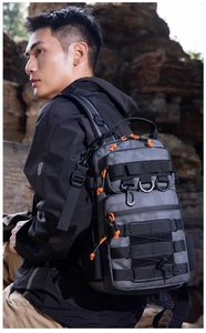 Close-up of tactical camo backpack featuring orange zipper pulls and rugged D-ring attachments