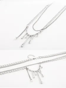 Détail du collier argenté double épaisseur avec pendentif lave et perle blanche subtile