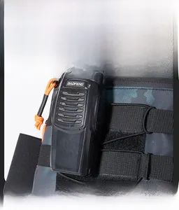 Detail showing the MOLLE system on camouflage tactical backpack with radio attachment
