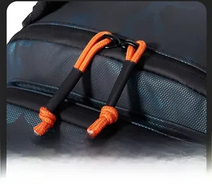Detail of durable camo backpack fabric with double zippers and orange pull cords