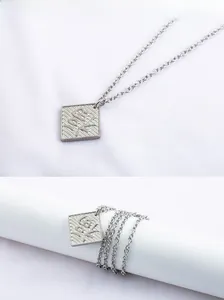 Macro view of square silver pendant featuring Lucky text and Chinese Fu character