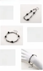 Detail of bamboo joint stainless steel bracelet with black beads and lobster clasp
