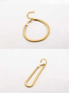 Close-up of golden flat snake bone chain bracelet with lobster clasp and extension