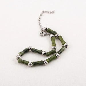 Men's green stone bamboo joint bead bracelet with stainless steel accents and lobster clasp