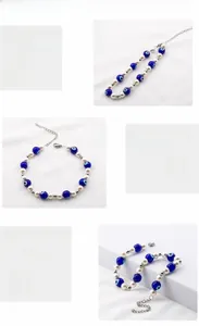 Macro detail of evil eye and pearl beaded bracelet with polished steel chain link