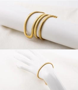 Detail of 18K gold plated herringbone snake chain bracelet on a white display