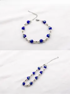 Detail of beaded evil eye bracelet with white pearls and silver lobster clasp