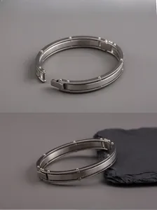 Industrial punk style silver titanium steel bracelet with mechanical clasp and stud detail