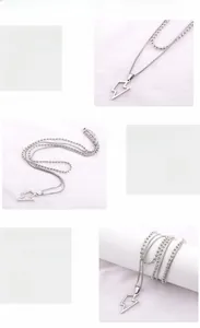 Detail of silver lightning pendant on double layered stainless steel chain for men