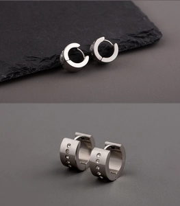 Detail view of silver stainless steel wide hoop earrings with five inlaid crystals for men