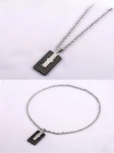 Detail of square puzzle pendant with black carbon fiber texture and forever love engraving