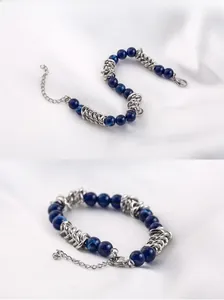 Detail of hip hop style bracelet with deep blue beads and silver steel link chain