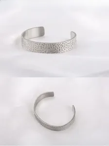Détail macro du bracelet jonc argenté en C avec texture métallique martelée irrégulière
