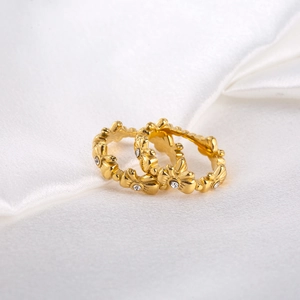 French style gold plated titanium steel flower rings with zircon stones on white silk