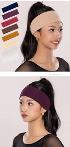 Vertical view of wide elastic headbands in various colors for yoga and fitness use