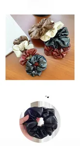 Macro detail of various color PU leather scrunchies with elegant textured pleats