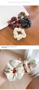 Detail of four retro faux leather scrunchies in burgundy, brown, black and beige