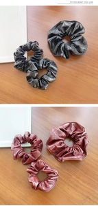 Close-up of premium PU leather scrunchies in classic black and vintage burgundy colors
