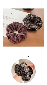 Detailed close-up of retro plaid fabric scrunchies with elegant ruffled edges and textures