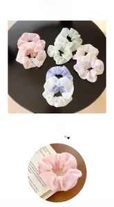 Close-up of pastel floral and solid scrunchies in chiffon, showing fabric texture and detail