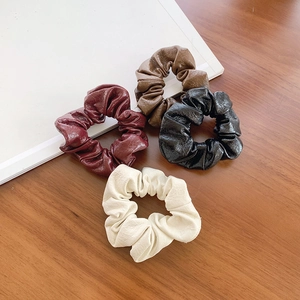 Vintage PU leather scrunchies set in four colors for elegant hair styling and ponytails