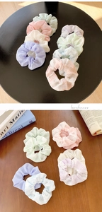 Detailed macro view of pastel floral scrunchies made of soft chiffon and organza