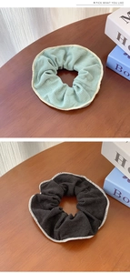 Detail of high-elasticity knitted scrunchies with contrast edges in green and brown
