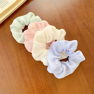 Set of four pastel floral hair scrunchies in mint, pink, white, and lavender chiffon fabric