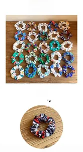 Detail of football print scrunchies and various patterned fabric hair ties on wood