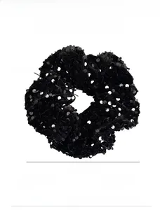 Detail of a large black velvet scrunchie with sequins showing 14cm diameter and 5.5cm width