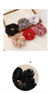 Close-up of velvet sequin scrunchies in six colors including black, pink and grey