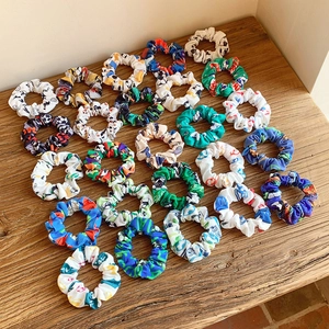 Various colorful sports patterned fabric scrunchies with football and basketball prints