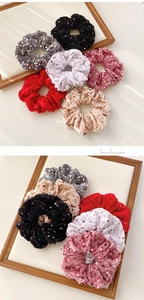 Detail view of 6-piece velvet sequin scrunchies set in assorted colors and soft texture