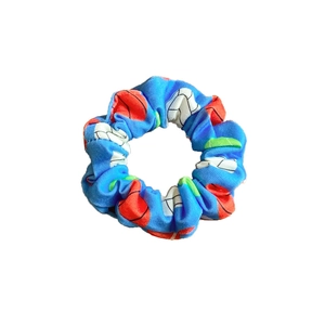 Blue sports-themed fabric scrunchie featuring red basketball and white volleyball prints