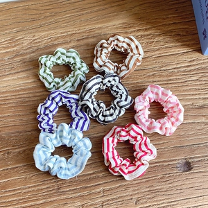Set of 7 colorful striped fabric scrunchies in diverse dopamine colors for ponytails