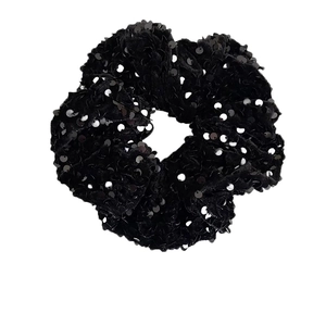 Sparkly black sequin velvet scrunchie for women hair styling in a minimalist white background