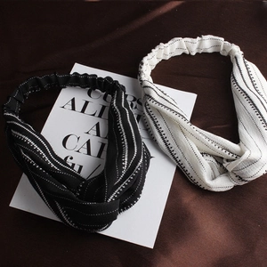 Set of two black and white abstract geometric cross-knot headbands with elastic bands