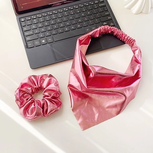 Close-up of metallic pink leather triangle bandana and scrunchie set for hair styling