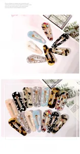Close-up of marble pattern acetate hair clips in various colors and floral patterns